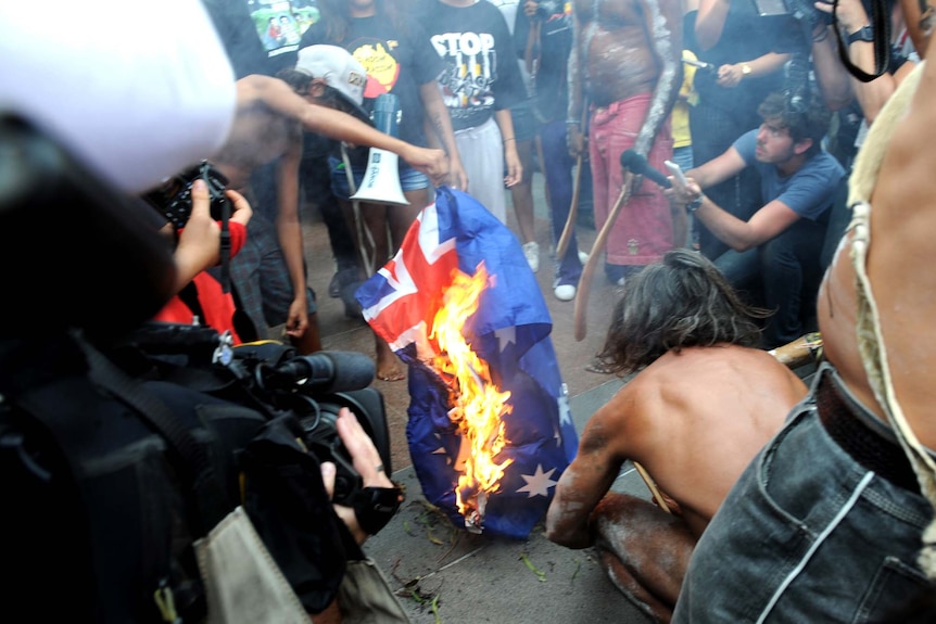 Protesters burn the Australian flag
