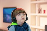 Child listening with headphones on.