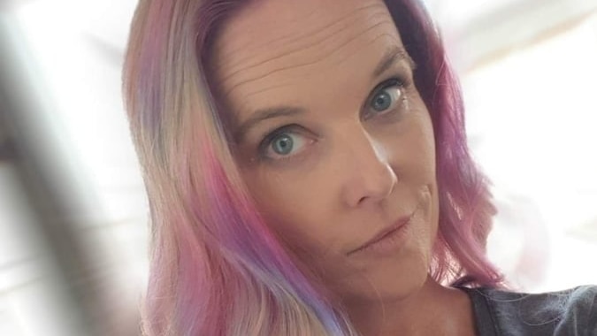 A women with long, silky blonde, pink and purple hair