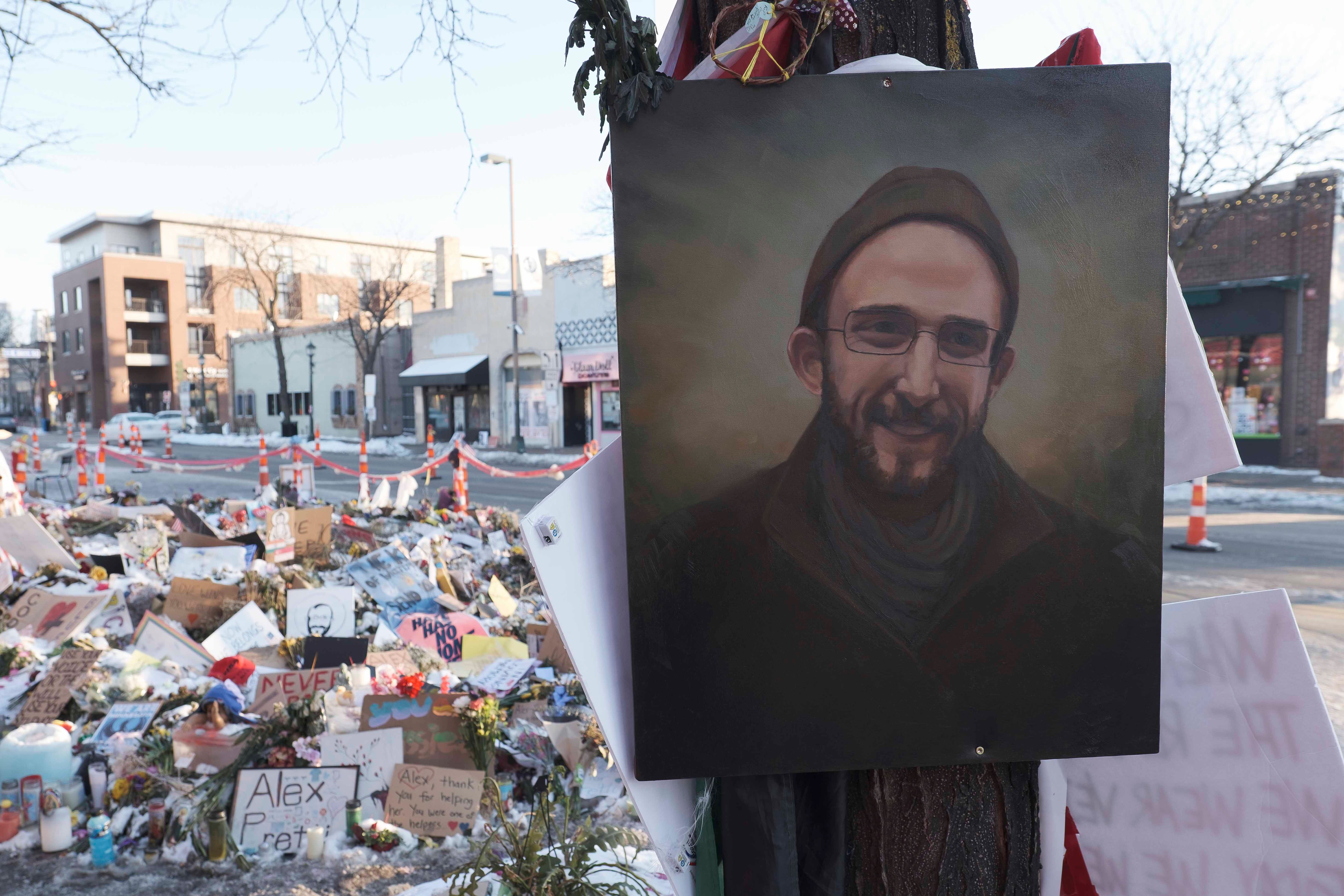 A portrait of Alex Pretti at a makeshift memorial site.