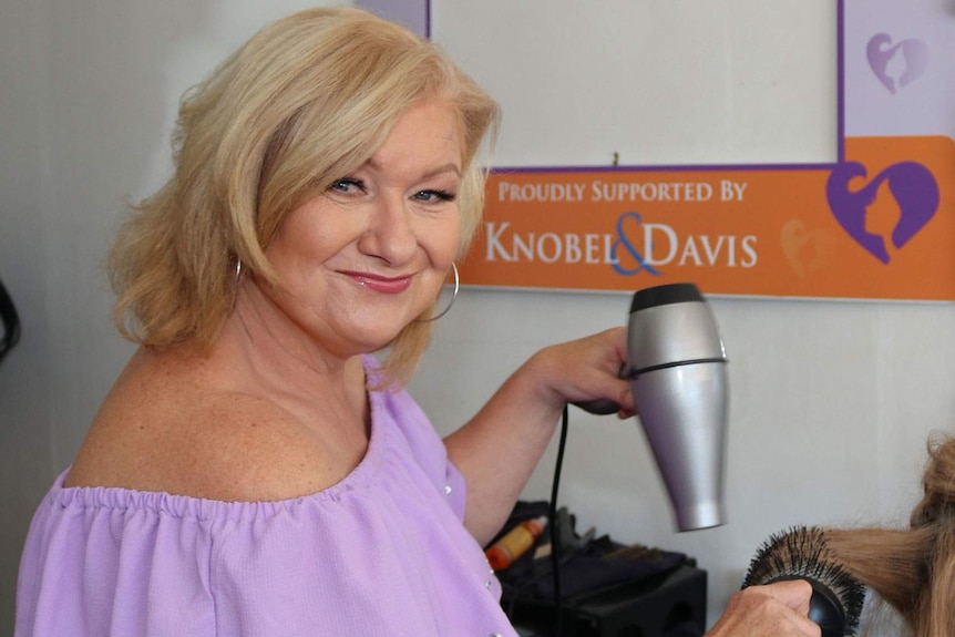 Sonia Colvin blow-dries the hair of a client at her Bribie Island salon.