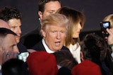 Donald Trump walks through a crowd of supporters