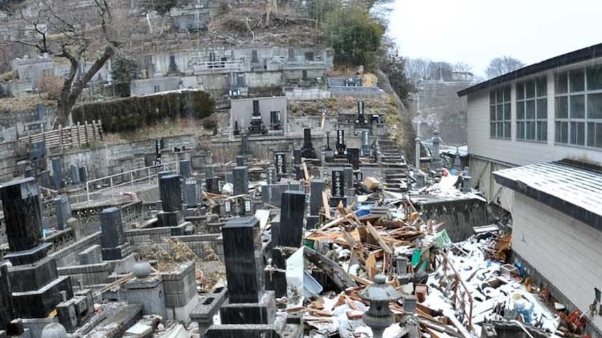 Rubble is strewn across a cemetery