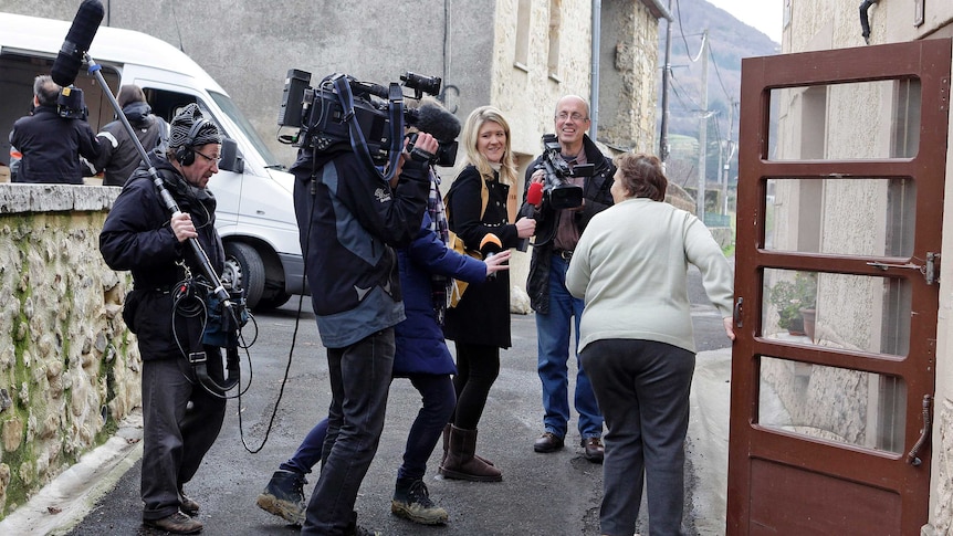 Members of the media interview a resident in Bugarach December 19, 2012.