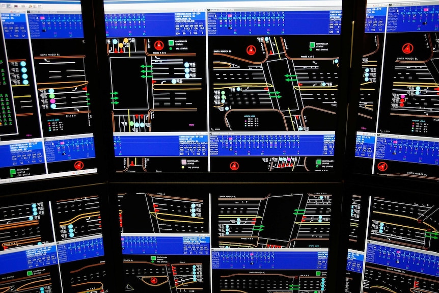 Computer screens showing traffic and roads.