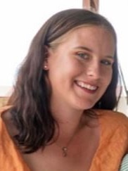 girl with dark brown hair and orange shirt