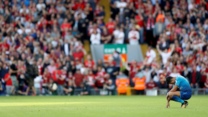 Arsenal's Alexis Sanchez grimaces after Liverpool loss
