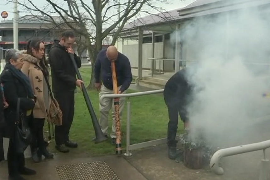 Indigenous smoking ceremony and two men playing didgeridoos