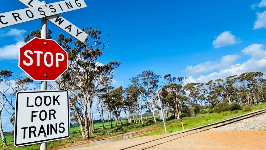 A WA railway line with a large stop look for trains picture in front.