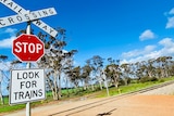 A WA railway line with a large stop look for trains picture in front.