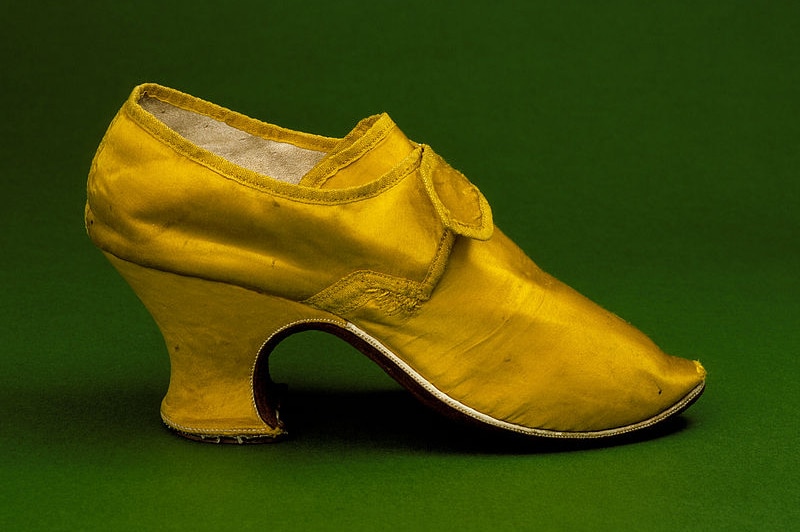 Woman's yellow silk shoe with louis heel, England, circa 1760-1765.