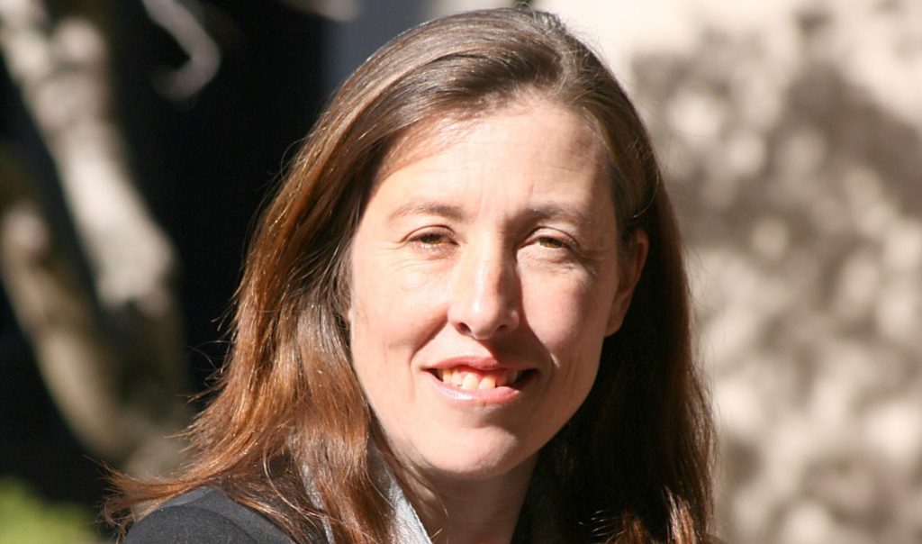 a woman smiling under the sun