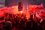 Demonstrators burn flares and wave Polish flags and signs during a far-right march in Warsaw.
