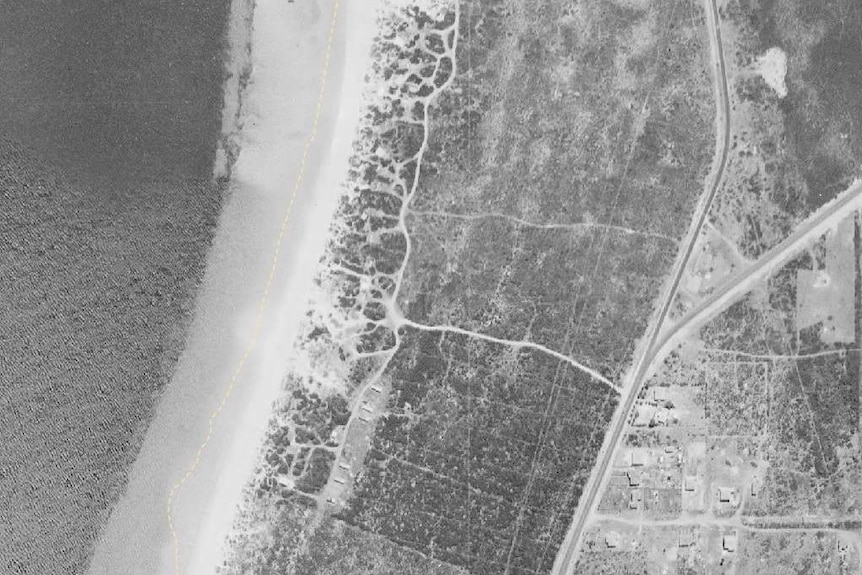 An aerial shot of the Kwinana Industrial precinct in 1954, showing scrubland and a cluster of beach side shacks.