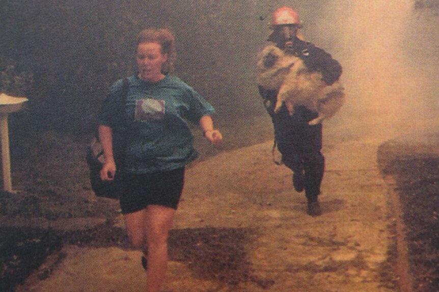 Firefighter Greg Mullins rescues a dog during a fire in his early days with FRNSW