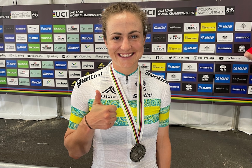An Australian female road cyclist gives the thumbs up with her silver medal.