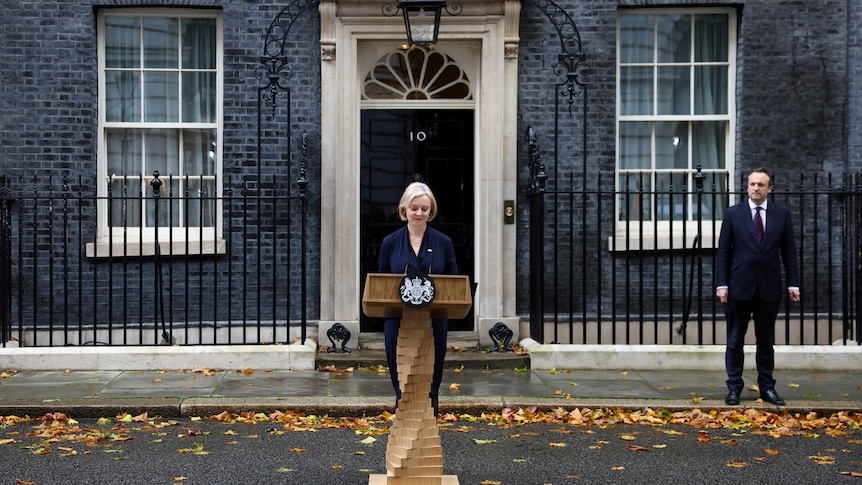 Liz Truss stands outside 10 Downing Street delivering a speech.