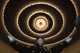 A Chinese military band conductor leads the band to rehearse ahead of the CPPCC, a red star is on the ceiling.