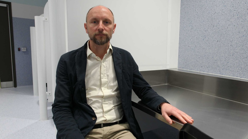 Nico Clark sitting inside the safe injecting centre.