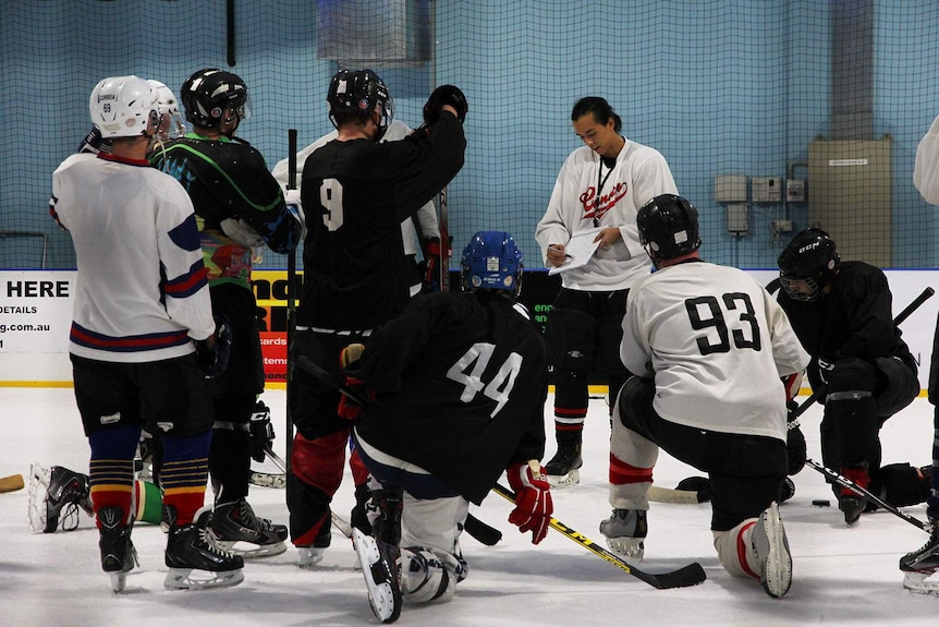 The Darwin team gathers on the ice to map out a game plan.