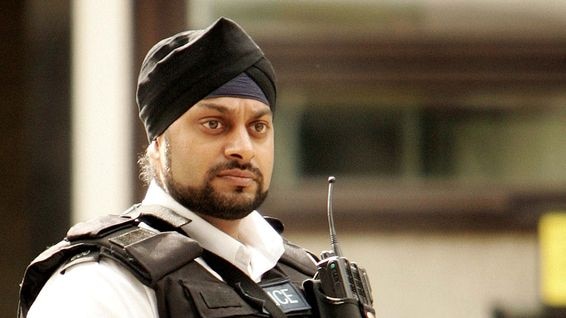 A Sikh police officer stands on duty outside London's New Scotland Yard