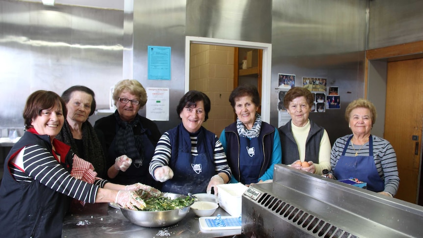 Group of women in kitchen cooking for Voula Delios
