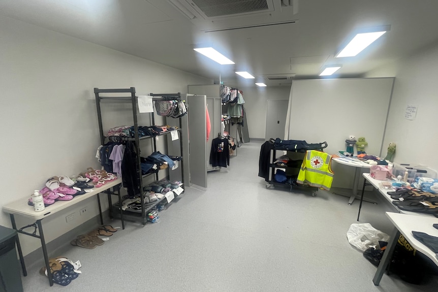 Clothing stacked on shelves and tables.