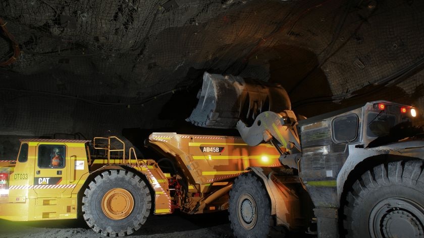 Miners operate machinery underground