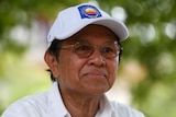 Cambodia's opposition leader Kem Sokha wearing a white cap.