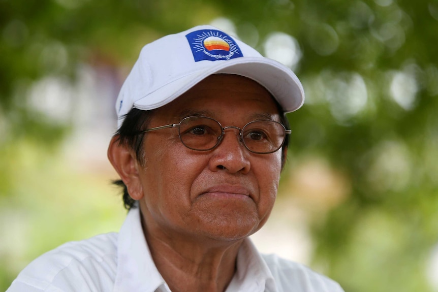 Cambodia's opposition leader Kem Sokha wearing a white cap.