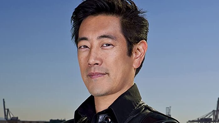 Mythbusters co-host Grant Imahara looks at the camera wearing a leather jacket