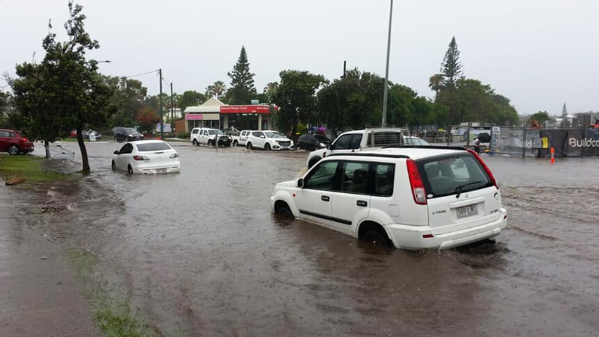 Cars driving through floodwaters at Kawana on the Sunshine Coast