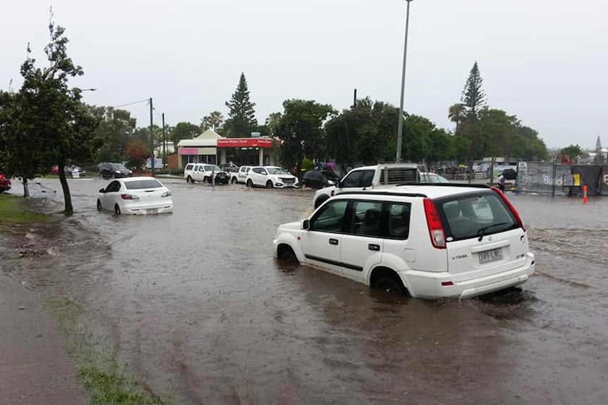 Cars driving through floodwaters at Kawana on the Sunshine Coast