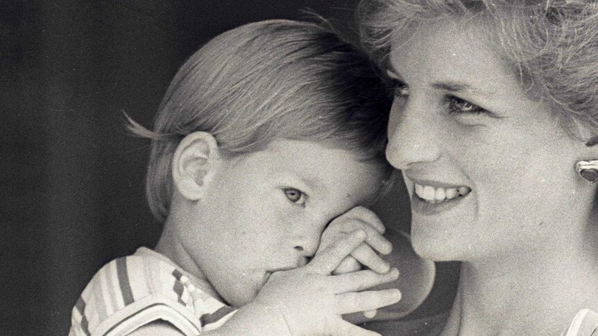 Young Prince Harry tries to hide behind his mother Princess Diana.