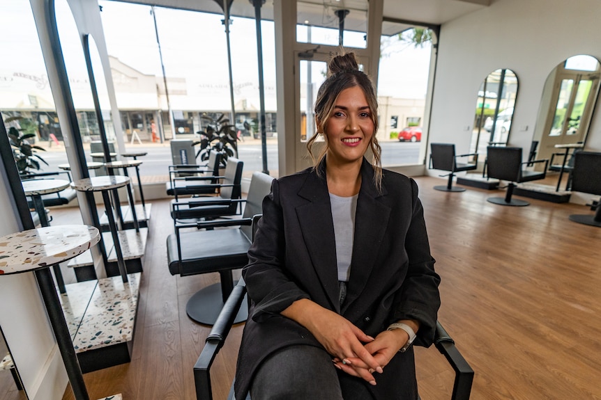 Ali Lucia sits on hairdressing chair