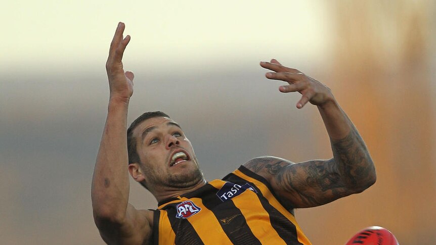 On report... Lance Franklin drops a mark under pressure from Nathan Bock.