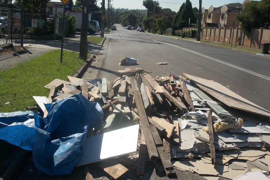 Building materials lie strewn across Boundary Road at Chester Hill.