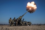 Ukrainian soldiers fire 2S7 Pion self propelled gun in a field.