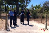 Forensic officers on a bush track in Balga at the start of a reserve near a primary school