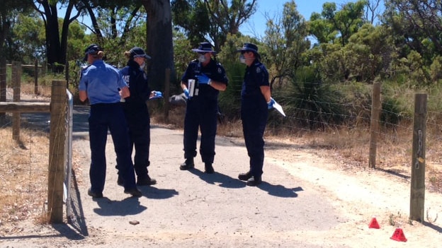 Forensic officers on a bush track in Balga at the start of a reserve near a primary school