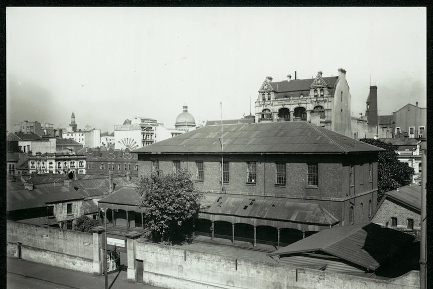 A black and white photo of an old school building
