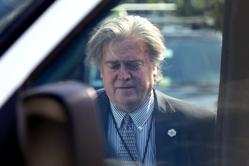 Steve Bannon looks tired and dishevelled as he enters a car.