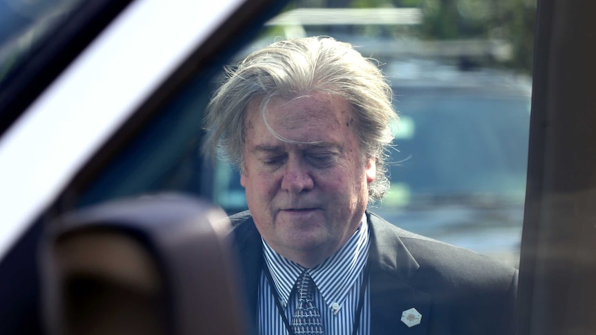 Steve Bannon looks tired and dishevelled as he enters a car.