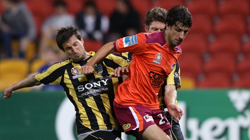 Tight tussle ... Thomas Broich is challenged by the Phoenix defence