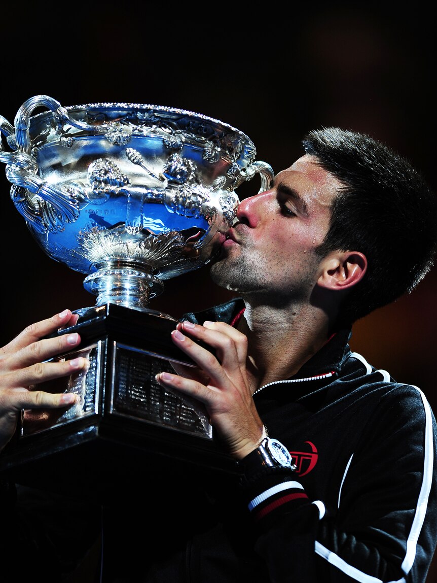 Epic battle ... Novak Djokovic kisses the trophy after beating Rafael Nadal (ABC News: Tony Trung)