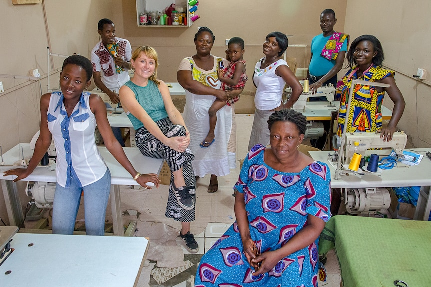 Anna Robertson and her Yevu team in Ghana surrounded by sewing machines to depict story about cultural appropriation in fashion.