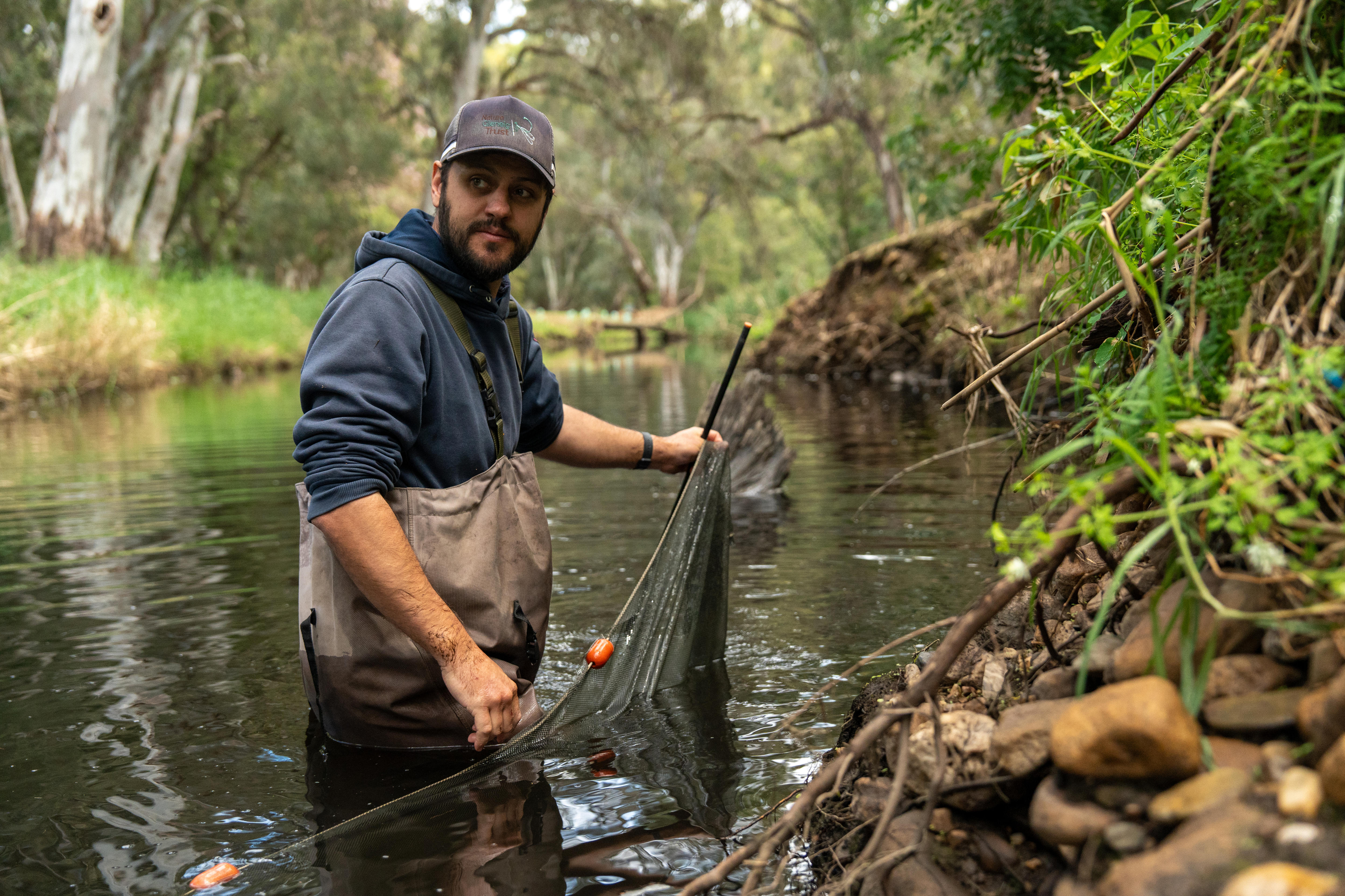 A man in a river with waders