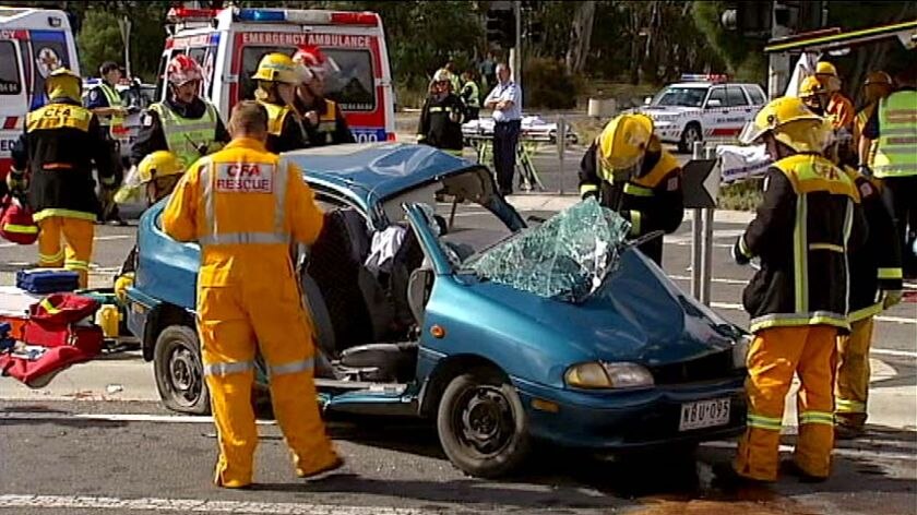 Emergency services personnel inspect a car at Lynbrook in Melbourne's south-east.