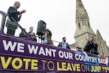 UK Independence Party leader Nigel Farage stands on a campaign bus for Brexit.