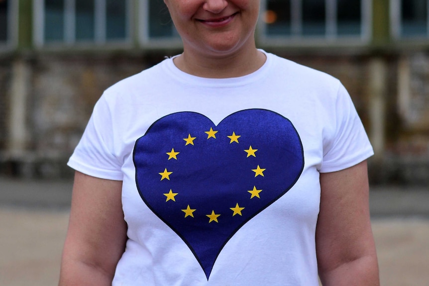 A woman wears a t-shirt with the European Union flag in the shape of a heart.